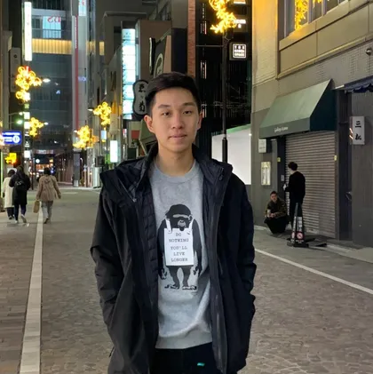 Caeleb Koharjo standing on a city street at night